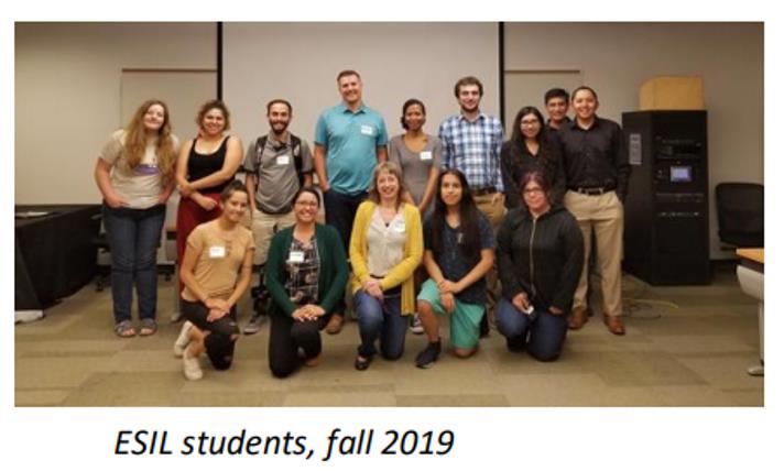 A group of professionals pose for a photo, with text that reads "ESIL students, fall 2019".