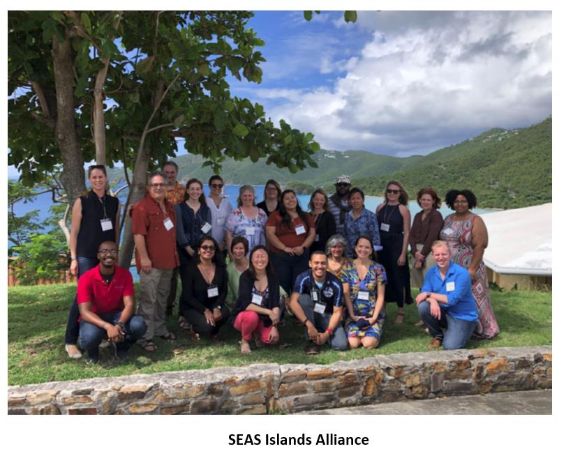 A group of people pose for a photo outdoors, with the text "SEAS Islands Alliance"