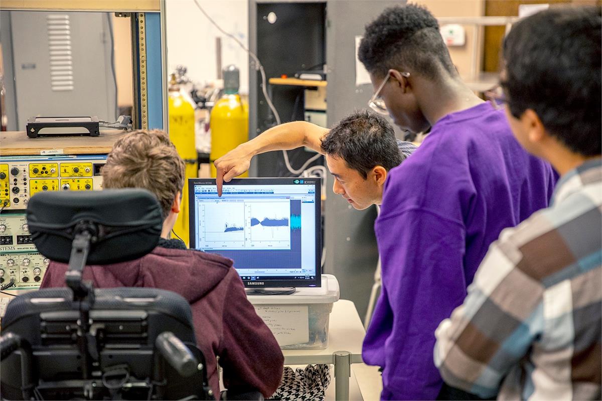 Students looking at a computer